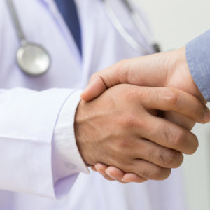 Doctor shakes hands with a patient