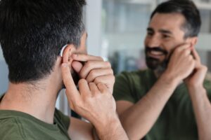 man turning on bluetooth hearing aids near McLean