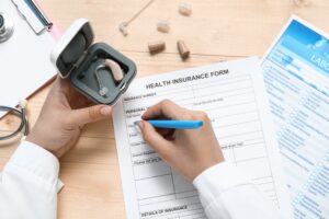 filling out insurance to help cover cost of hearing aids in Fairfax County