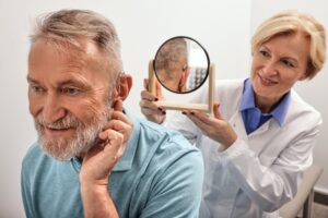 man seeing an audiologist for various levels of hearing loss